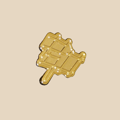 gold cutout pin in the shape of our p90 logo